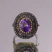 An amethyst & diamond dress ring, the oval-cut amethyst weighing approx. 2.6 carats, set within an