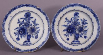 A pair of 18th century Dutch delft small shallow dishes, each painted with blue & white floral
