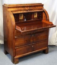 An early 19th century French figured mahogany cylinder-front bureau with a fitted interior & pull-