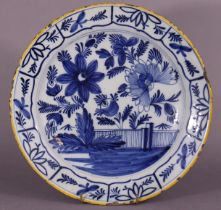 An 18th century Dutch delft large shallow dish with blue & white floral decoration and yellow rim,