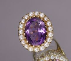 An amethyst ring, the large oval-cut stone weighing approx. 6.5 carats, within a border of small