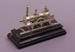 A Victorian cast silver model of an early steam locomotive, 7.5cm long (9.5cm including track),