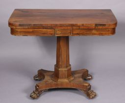 A regency rosewood card table with rounded corners to the rectangular fold-over top, inset