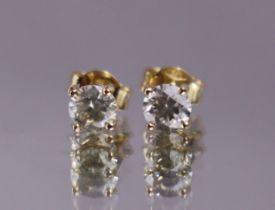 A pair of diamond solitaire ear studs, the round brilliant-cut stones with total weight of approx.