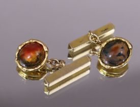 A pair of moss-agate oval cabochon cuff-links with 9ct gold bar fasteners. (6.7gm weighable).