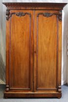 An early Victorian mahogany wardrobe, with foliate moulded cornice, fitted two hanging sections