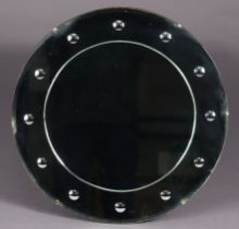 An early 20th century frameless wall mirror with convex sorcerer-type roundels to the wide border, 5