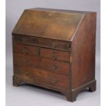 A 19th century oak bureau with a fitted interior enclosed by a fall-front above a mock-drawer &