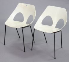 A pair of retro-style white finish tub-shaped stacking chairs each on four black-metal finish legs.