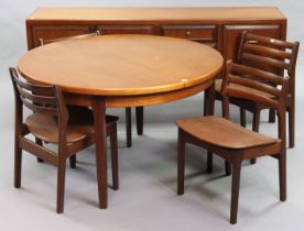 A 1970’s teak circular extending dining table with an additional leaf, & on four square tapered