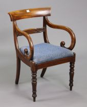 A 19th century mahogany bow-back carver chair with a carved centre rail, padded drop-in-seat, & on