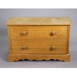 An oak & pine dwarf chest fitted two long graduated drawers with turned knob handles, & on a