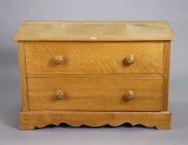 An oak & pine dwarf chest fitted two long graduated drawers with turned knob handles, & on a