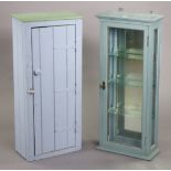 A pale blue painted wall cabinet with a mirrored back & with three adjustable shelves enclosed by