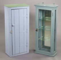 A pale blue painted wall cabinet with a mirrored back & with three adjustable shelves enclosed by