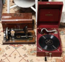 A vintage Mastertone portable gramophone in red fibre-covered case; & a vintage Vesta hand sewing