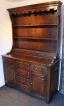 A good quality reproduction oak dresser in the 18th century style, fitted three shelves and six