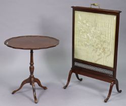 An Edwardian mahogany fire-screen inset with a silk embroidered floral panel, & on a mahogany tripod