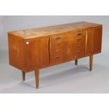 A teak small sideboard fitted four long graduated drawers to centre flanked by a cupboard to