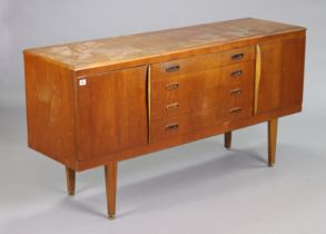 A teak small sideboard fitted four long graduated drawers to centre flanked by a cupboard to