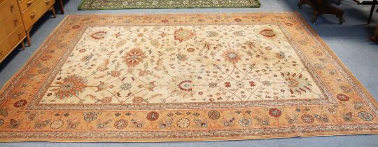 A Royal Keshan “Agra” wool carpet of cream ground & with all-over multi-coloured geometric design