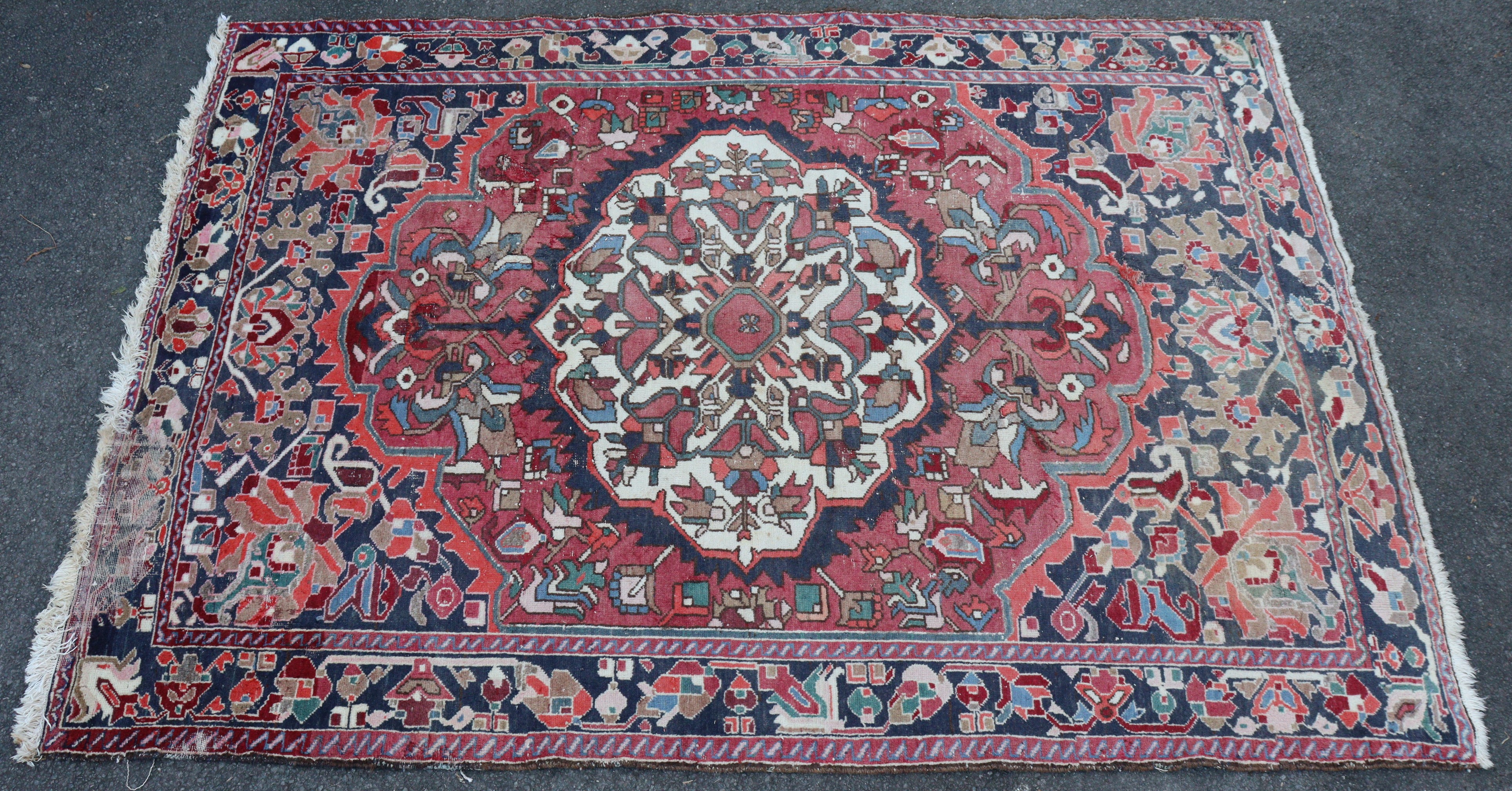 A Bakhtiar carpet of madder ground with central medallion & all-over repeating geometric designs in