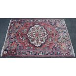 A Bakhtiar carpet of madder ground with central medallion & all-over repeating geometric designs in