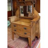 An early 20th century Arts & Crafts oak dressing chest, with rectangular adjustable mirror inset