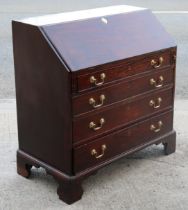 A Georgian mahogany bureau having a fitted interior enclosed by a fall-front above four long