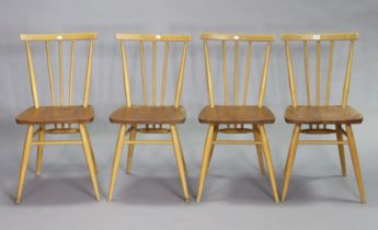 A set of four Ercol light elm spindle-back kitchen chairs each with a hard seat, & on turned legs