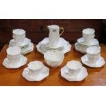 A Coalport bone china thirty-eight piece part tea service of white ground & with gilt rims.