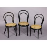 A Thonet ebonised child’s chair with gold painted decoration & cane circular seat, & two similar