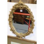 A gilt frame oval wall mirror, 61cm x 44cm & fifteen various pictures.