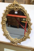 A gilt frame oval wall mirror, 61cm x 44cm & fifteen various pictures.