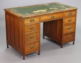 A late Victorian mahogany knee-hole desk inset tooled green leather cloth, fitted with an