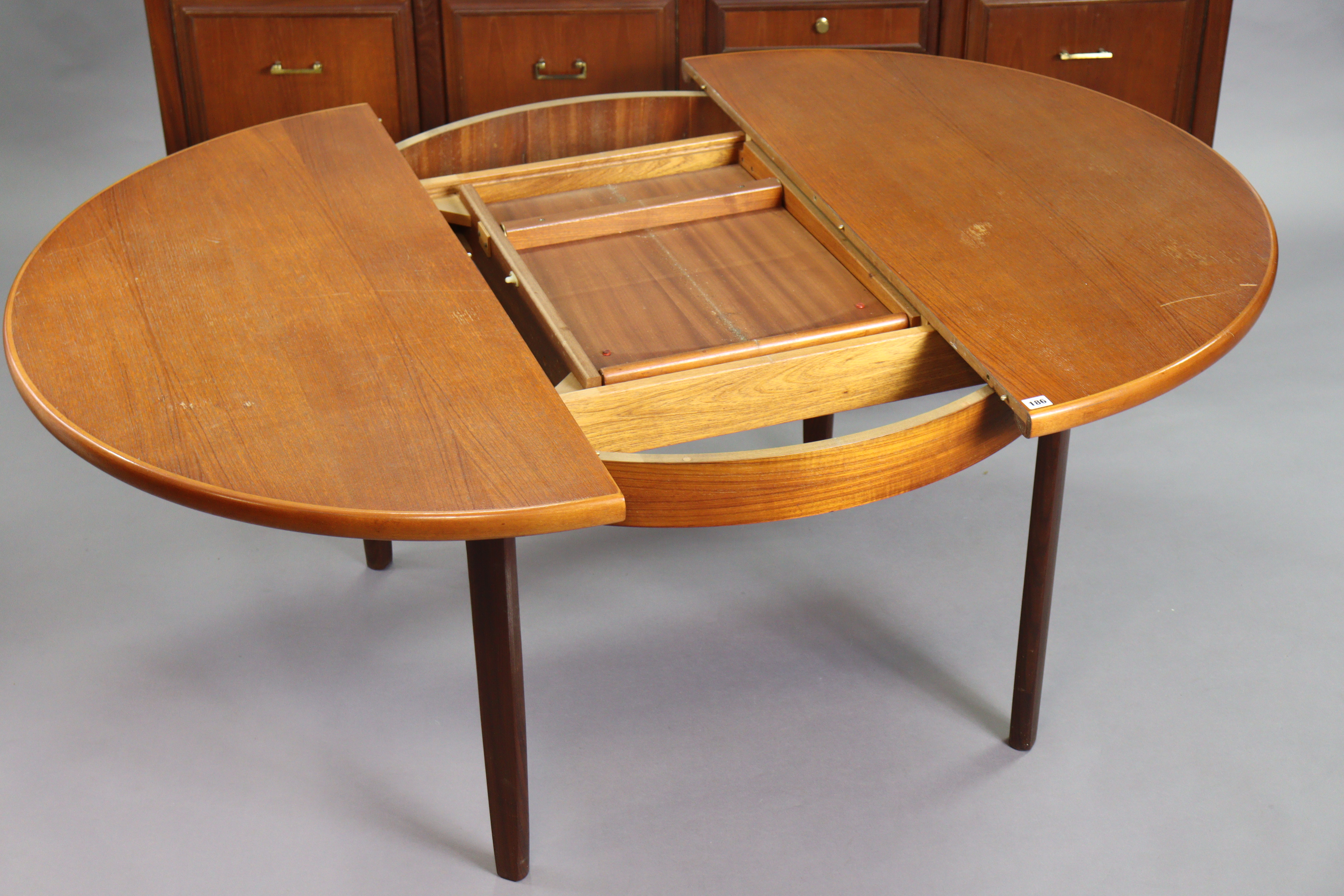 A 1970’s teak circular extending dining table with an additional leaf, & on four square tapered - Image 3 of 17
