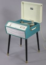 A mid-20th century Dansette “Monarch” floor-standing turntable on turquoise & cream fibre-covered