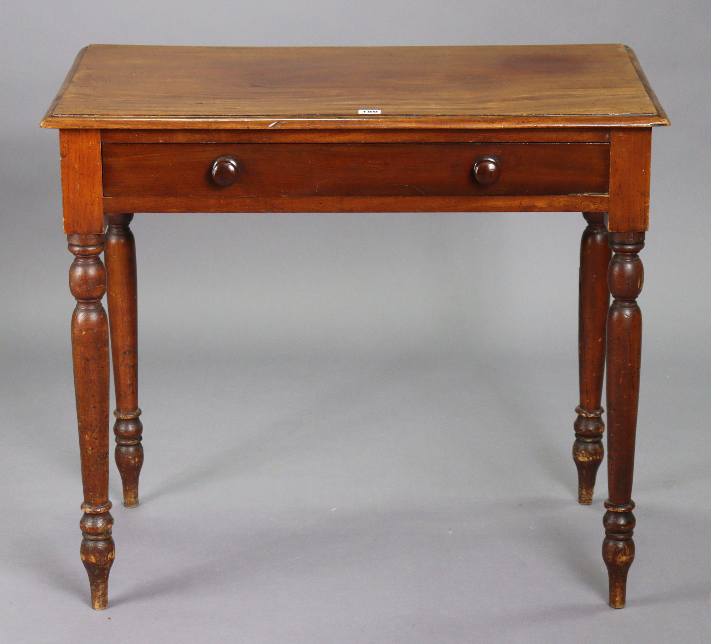 A Victorian mahogany side table with a moulded edge to the rectangular top, fitted frieze