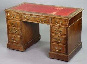 A Victorian mahogany pedestal desk inset gilt-tooled crimson leather, fitted with an arrangement