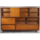 A mid-20th century teak tall wall unit fitted with an arrangement of shelves & cupboards, & on short