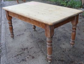 A Victorian pine kitchen table with rounded corners & moulded edge to the rectangular top, & on four