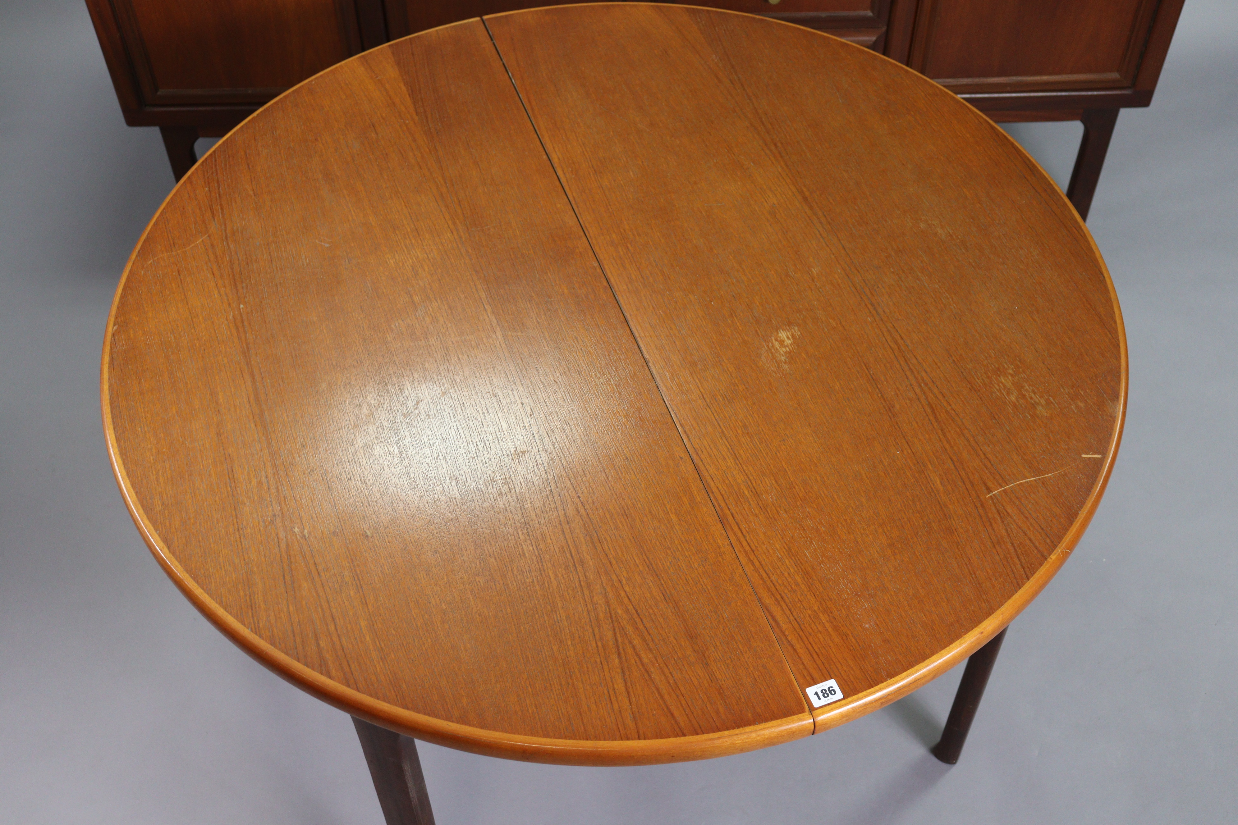 A 1970’s teak circular extending dining table with an additional leaf, & on four square tapered - Image 5 of 17