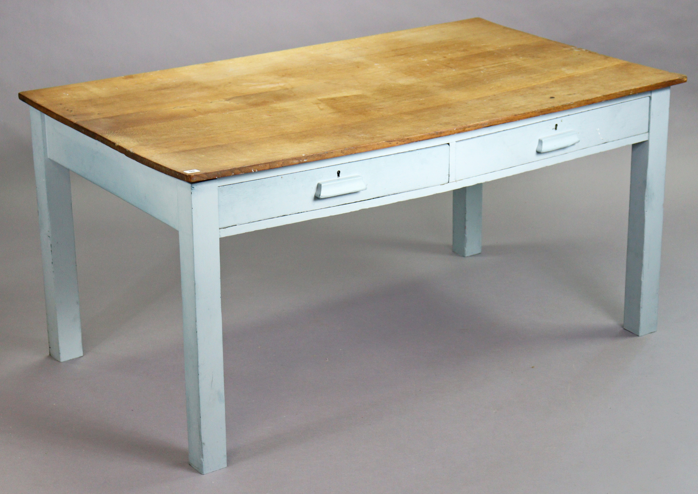 An oak kitchen table with a rectangular top, the pale blue painted underframe fitted two frieze