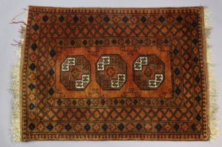 A Turkoman rug of madder ground with three medallions to centre in multiple geometric borders, 146cm