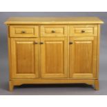 A light oak/ash sideboard fitted three frieze drawers above cupboards enclosed by three fielded pa