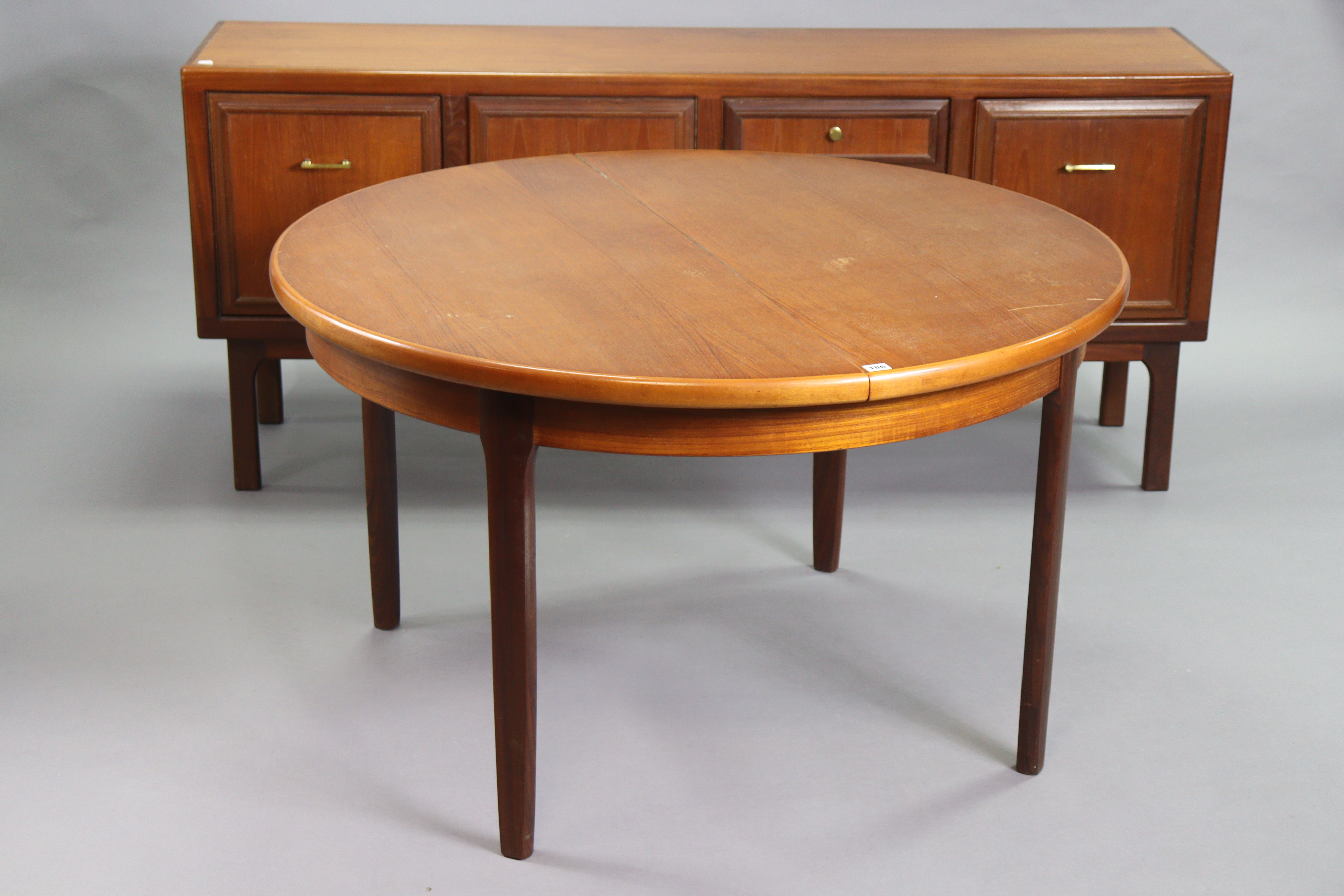 A 1970’s teak circular extending dining table with an additional leaf, & on four square tapered - Image 2 of 17