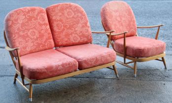 An Ercol light elm spindle-back two-seater settee with loose cushions to the seat & back upholstered