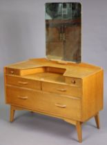 A mid-20th century G-Plan oak dressing table with a rectangular swing mirror to the stage back,