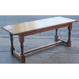 An oak refectory table with a rectangular top, & on four baluster turned legs with plain stretchers,