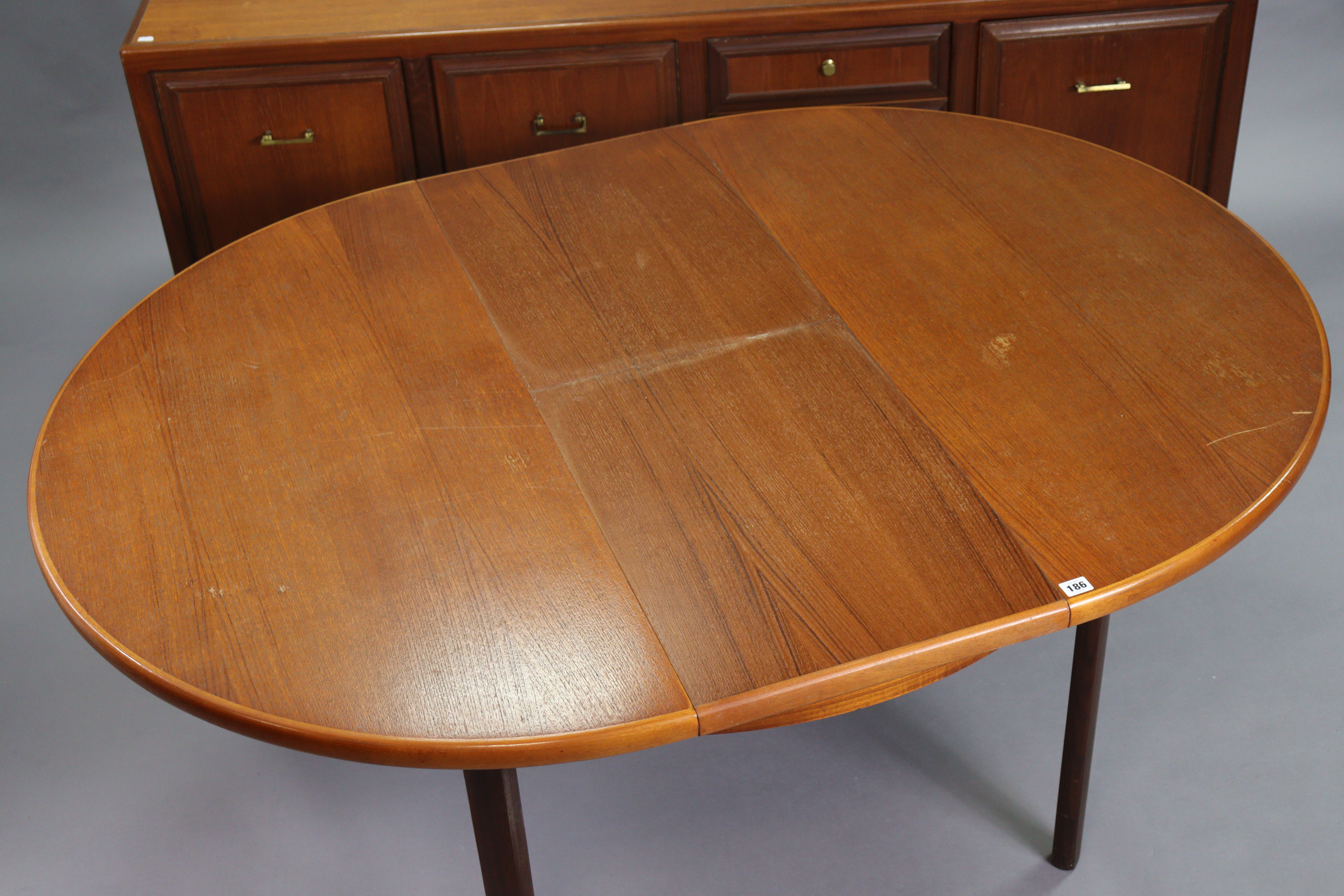 A 1970’s teak circular extending dining table with an additional leaf, & on four square tapered - Image 4 of 17